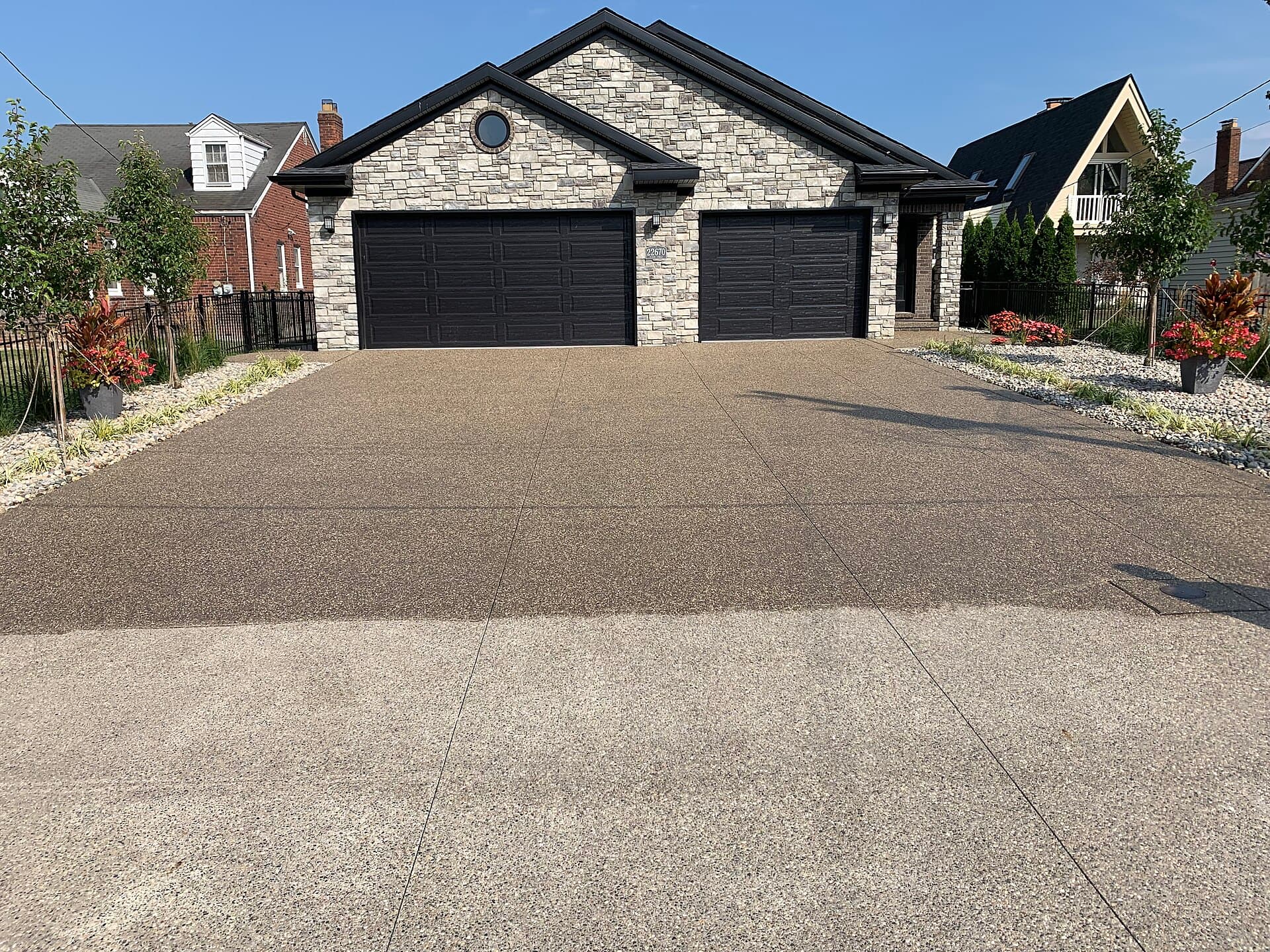 Exposed aggregate concrete being washed and sealed